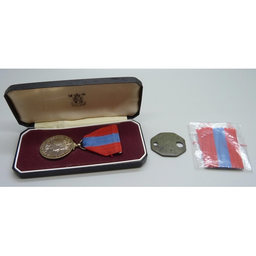 1018 - An Imperial Service medal, For Faithful Service, Douglas Raymond Smith, with a dog tag, D. Smith