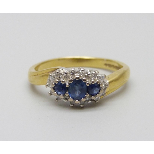 1021 - An 18ct gold sapphire and diamond cluster ring, 4g, L