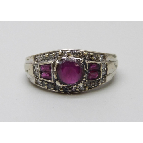 1031 - A white metal ruby and diamond set ring, stamped 750, 4.5g, O