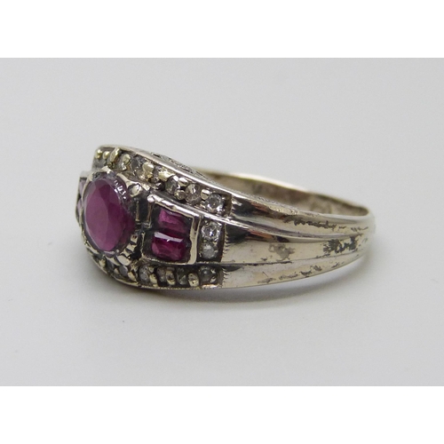 1031 - A white metal ruby and diamond set ring, stamped 750, 4.5g, O