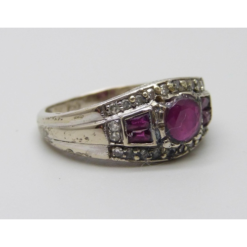 1031 - A white metal ruby and diamond set ring, stamped 750, 4.5g, O