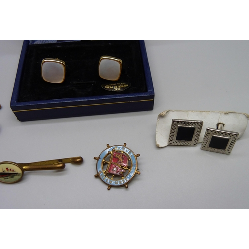 1037 - A pair of Queen Mary cruise liner cufflinks with matching tie-clip, an enamelled badge and two other... 