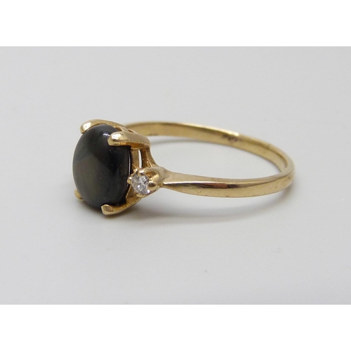 1044 - A 14ct gold ring set with a cat's eye and diamonds, 2.3g, O