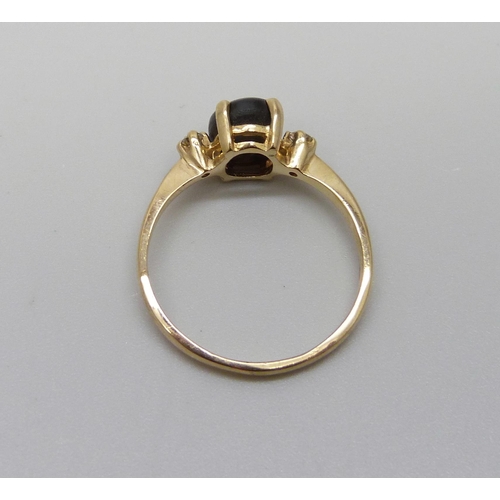 1044 - A 14ct gold ring set with a cat's eye and diamonds, 2.3g, O