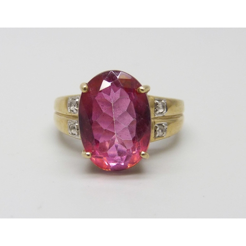 1045 - A 9ct gold ring set with an oval ruby and four white spinel, 6.2g, N