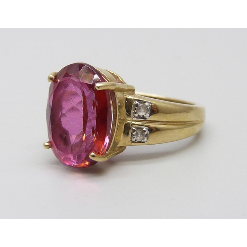 1045 - A 9ct gold ring set with an oval ruby and four white spinel, 6.2g, N