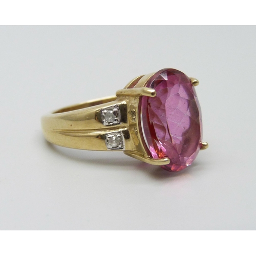 1045 - A 9ct gold ring set with an oval ruby and four white spinel, 6.2g, N