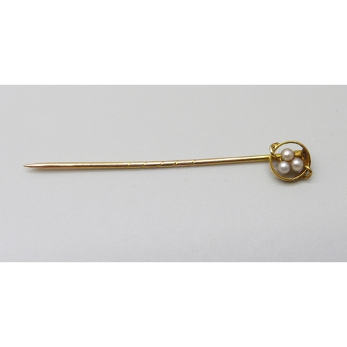 1046 - A yellow metal stick pin set with seed pearls, 1g