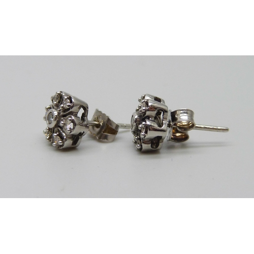 1053 - A pair of white metal flower design diamond set cluster earrings, the butterflies marked 375, 2.4g, ... 