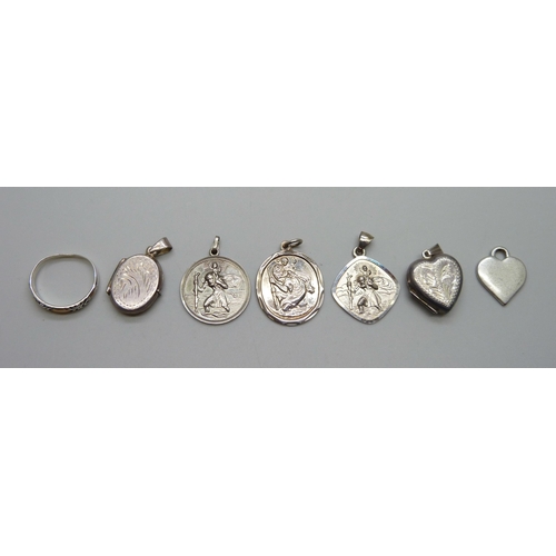 1055 - A collection of silver including two St Christopher pendants, two lockets and a ring, together with ... 