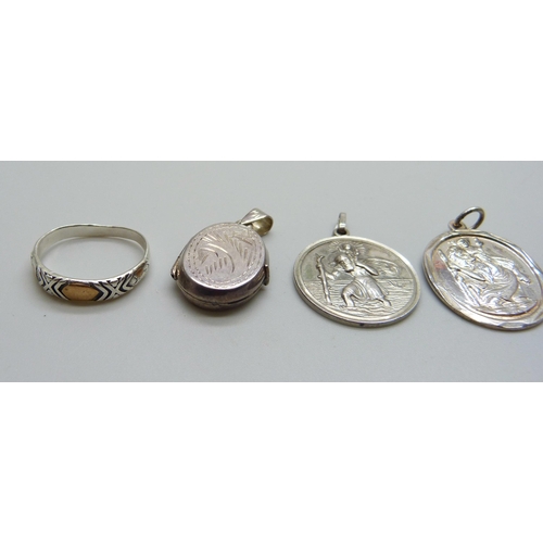 1055 - A collection of silver including two St Christopher pendants, two lockets and a ring, together with ... 