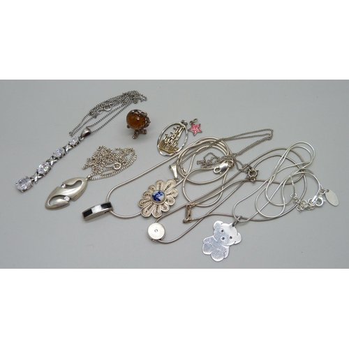 1081 - A collection of silver pendants and chains, 49g