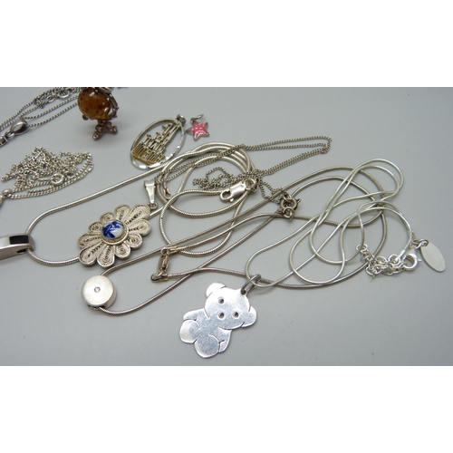 1081 - A collection of silver pendants and chains, 49g