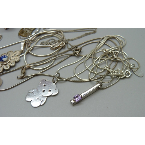 1081 - A collection of silver pendants and chains, 49g