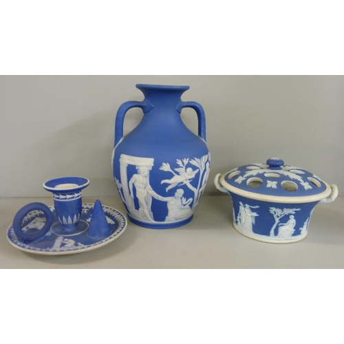 603 - Three items of Wedgwood dark blue jasper; twin handled vase, pot pourri and chamberstick