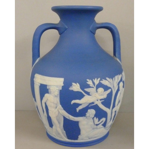 603 - Three items of Wedgwood dark blue jasper; twin handled vase, pot pourri and chamberstick