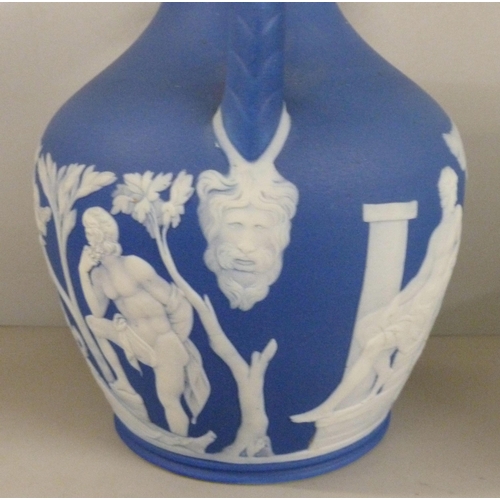 603 - Three items of Wedgwood dark blue jasper; twin handled vase, pot pourri and chamberstick