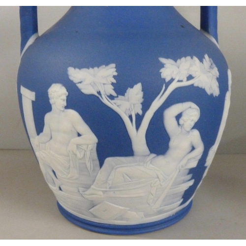 603 - Three items of Wedgwood dark blue jasper; twin handled vase, pot pourri and chamberstick