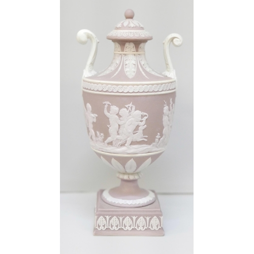 606 - A Wedgwood lilac jasper twin handled urn and cover on a square stand, 19cm, restored