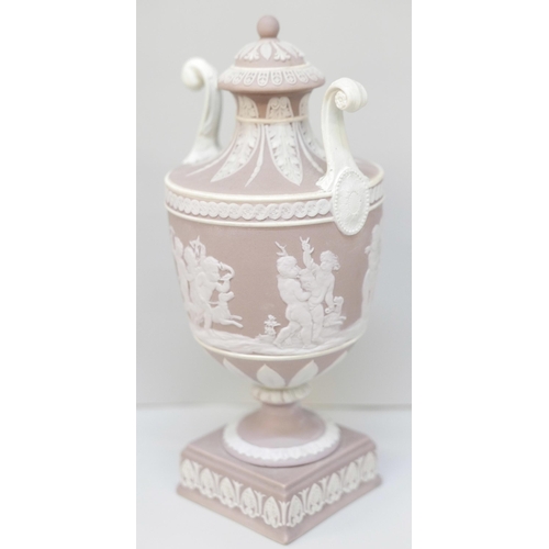 606 - A Wedgwood lilac jasper twin handled urn and cover on a square stand, 19cm, restored