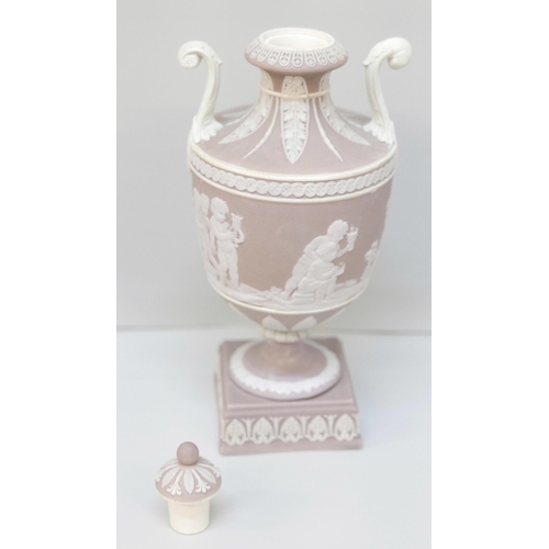 606 - A Wedgwood lilac jasper twin handled urn and cover on a square stand, 19cm