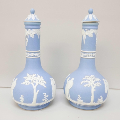 612 - A pair of Wedgwood blue jasper bottle vases, with covers, 17.5cm