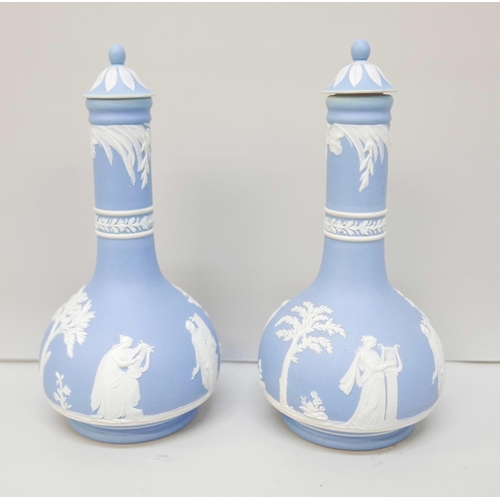 612 - A pair of Wedgwood blue jasper bottle vases, with covers, 17.5cm