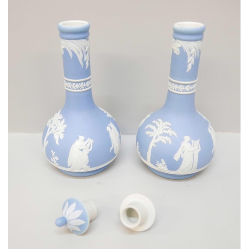 612 - A pair of Wedgwood blue jasper bottle vases, with covers, 17.5cm