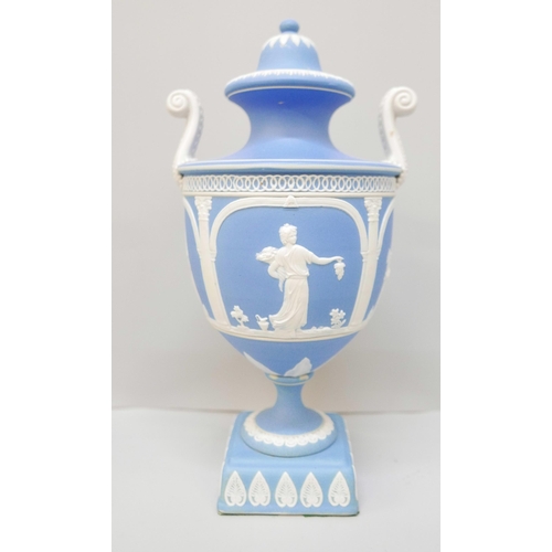 615 - A Wedgwood blue jasper twin handled urn with cover on a square plinth, 28cm