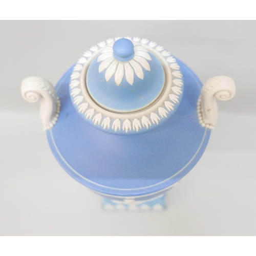 615 - A Wedgwood blue jasper twin handled urn with cover on a square plinth, 28cm