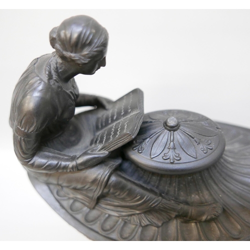 616 - A Wedgwood black basalt vestal oil lamp and cover, the female figure reading a book seated upon the ... 