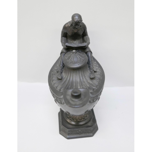 616 - A Wedgwood black basalt vestal oil lamp and cover, the female figure reading a book seated upon the ... 