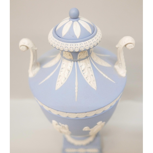 618 - A Wedgwood blue jasper twin handled urn with cover on a square plinth, 27cm, lid chipped, one handle... 