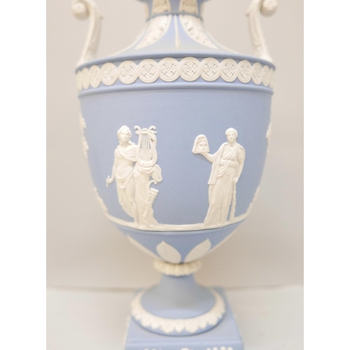 618 - A Wedgwood blue jasper twin handled urn with cover on a square plinth, 27cm, lid chipped, one handle... 