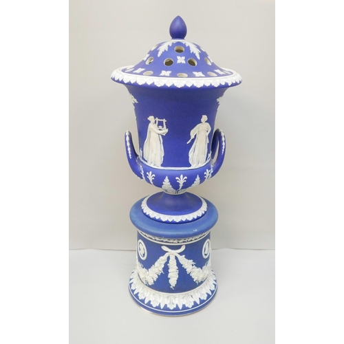 619 - A large Wedgwood dark blue jasper covered twin handled urn on a stand, with pierced cover, 42cm