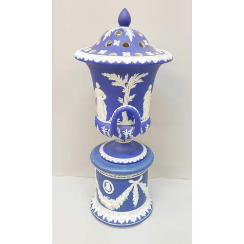 619 - A large Wedgwood dark blue jasper covered twin handled urn on a stand, with pierced cover, 42cm