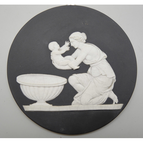 626 - A pair of Wedgwood black and white circular plaques and an oval plaque, each with classical scenes