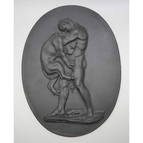 628 - A Wedgwood black basalt oval plaque, Hercules Wrestling the Nemean Lion, 186mm x 142mm