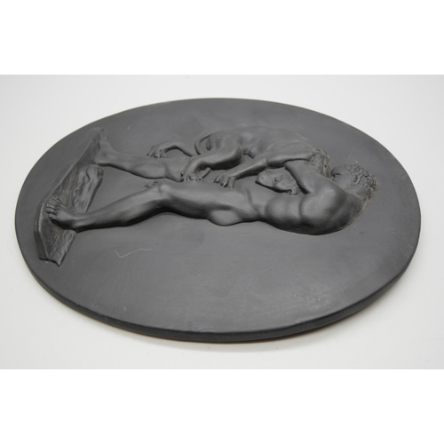 628 - A Wedgwood black basalt oval plaque, Hercules Wrestling the Nemean Lion, 186mm x 142mm