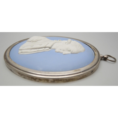 646 - A Wedgwood blue jasper oval medallion of Captain James Cook in profile, in a plated frame