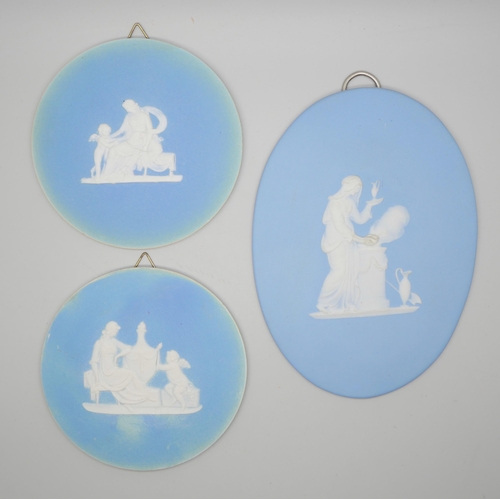 648 - Two circular and one oval Wedgwood blue jasper plaques, classical scenes