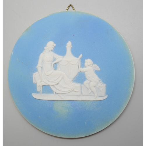 648 - Two circular and one oval Wedgwood blue jasper plaques, classical scenes