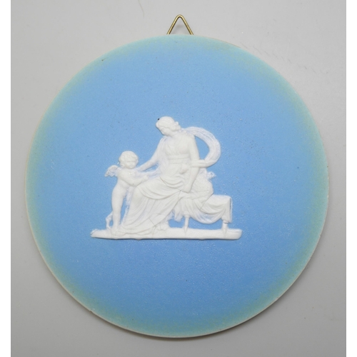 648 - Two circular and one oval Wedgwood blue jasper plaques, classical scenes