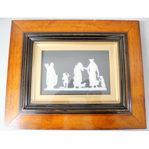 652 - Two Wedgwood black and white jasper plaques, framed