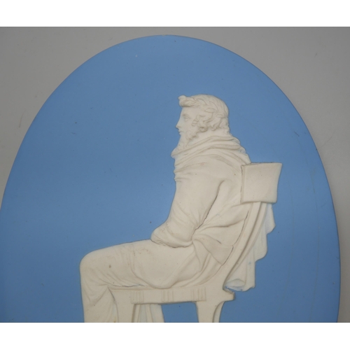 656 - A Wedgwood jasper oval plaque of a seated man in profile