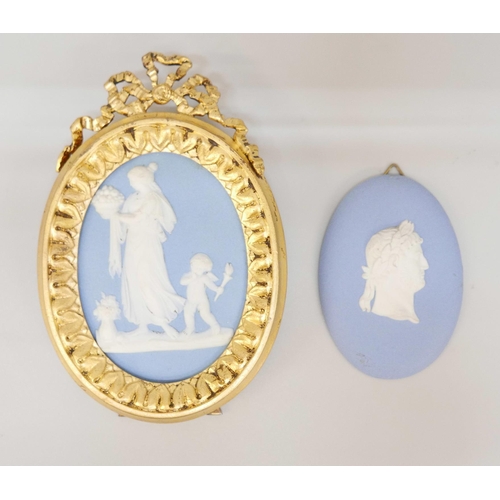 662 - A Wedgwood oval jasper medallion of a classical maiden and cherub in a gilt metal frame with stand a... 