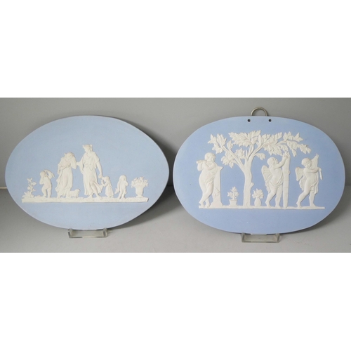 663 - Two Wedgwood blue jasper large oval plaques, decorated with maidens and cherubs