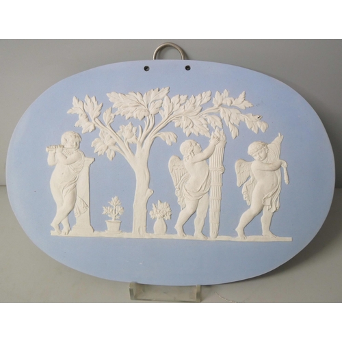 663 - Two Wedgwood blue jasper large oval plaques, decorated with maidens and cherubs