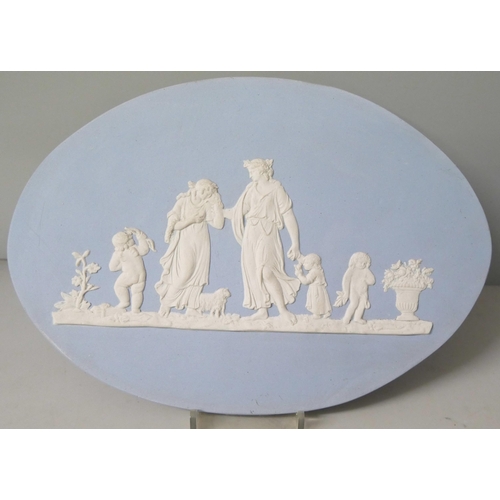 663 - Two Wedgwood blue jasper large oval plaques, decorated with maidens and cherubs