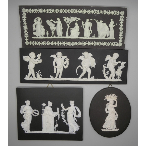 665 - Four Wedgwood black and white Jasper plaques, three rectangular, one oval